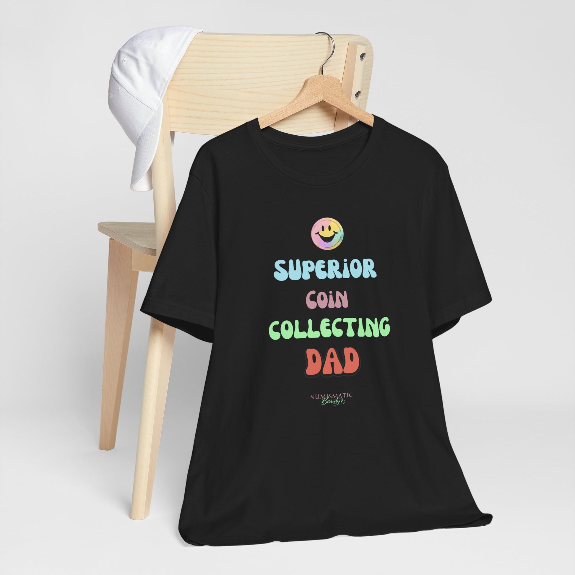 Superior Coin Collecting Dad Unisex Tee, black with colorful text and a smiley face, ideal for casual wear. Made from soft, breathable cotton for comfort.