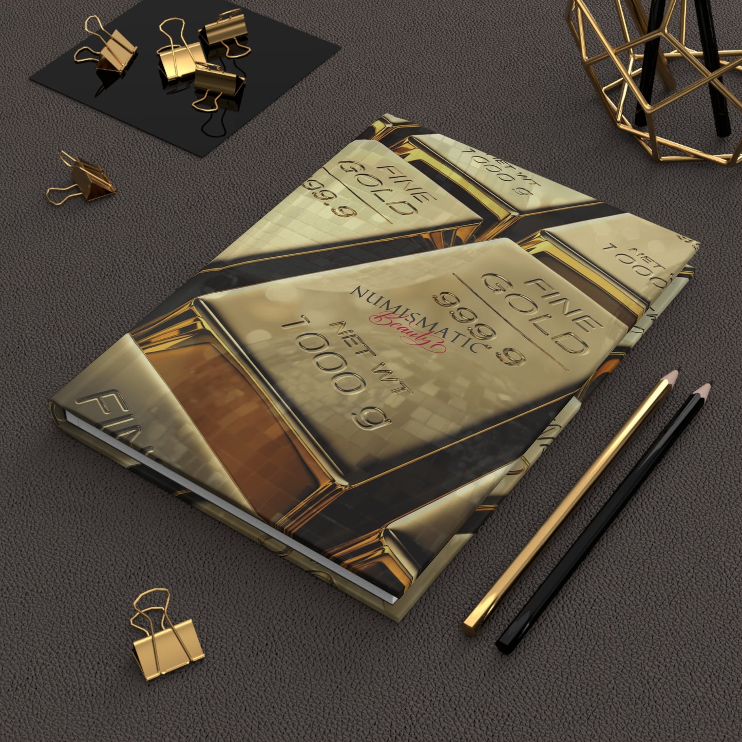 Gold Bar Journal by Numismatic Beauty, shown on a table with pencils. Features a matte cover and designed for gold investors and collectors.