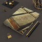 Gold Bar Journal by Numismatic Beauty, shown on a table with pencils. Features a matte cover and designed for gold investors and collectors.